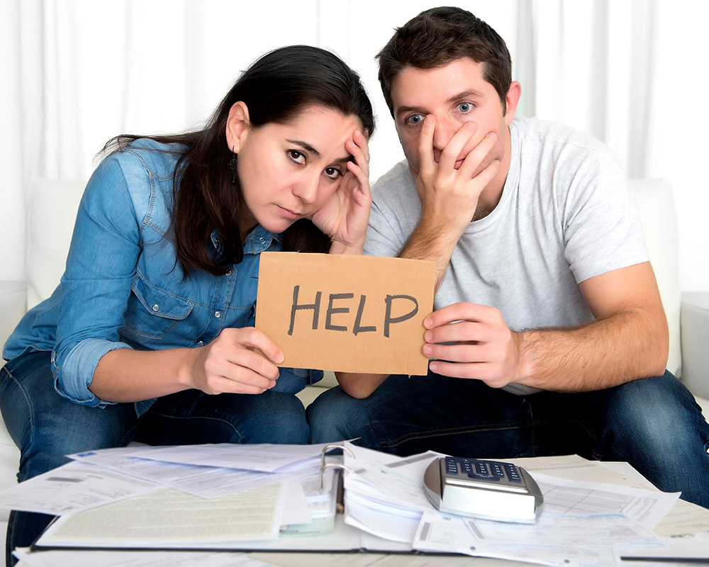 young couple worried at home in bad financial situation stress image